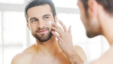 A man with blackheads applying cream