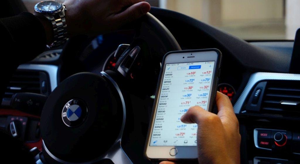 man trading on his phone
