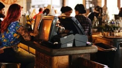 Cashier in front of Restaurant Management Software