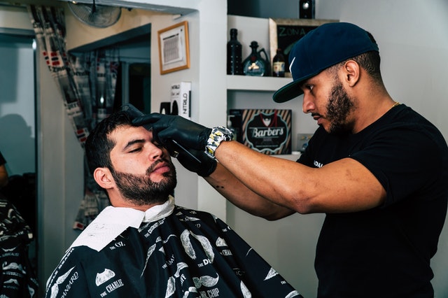Man having haircut at barbers shop