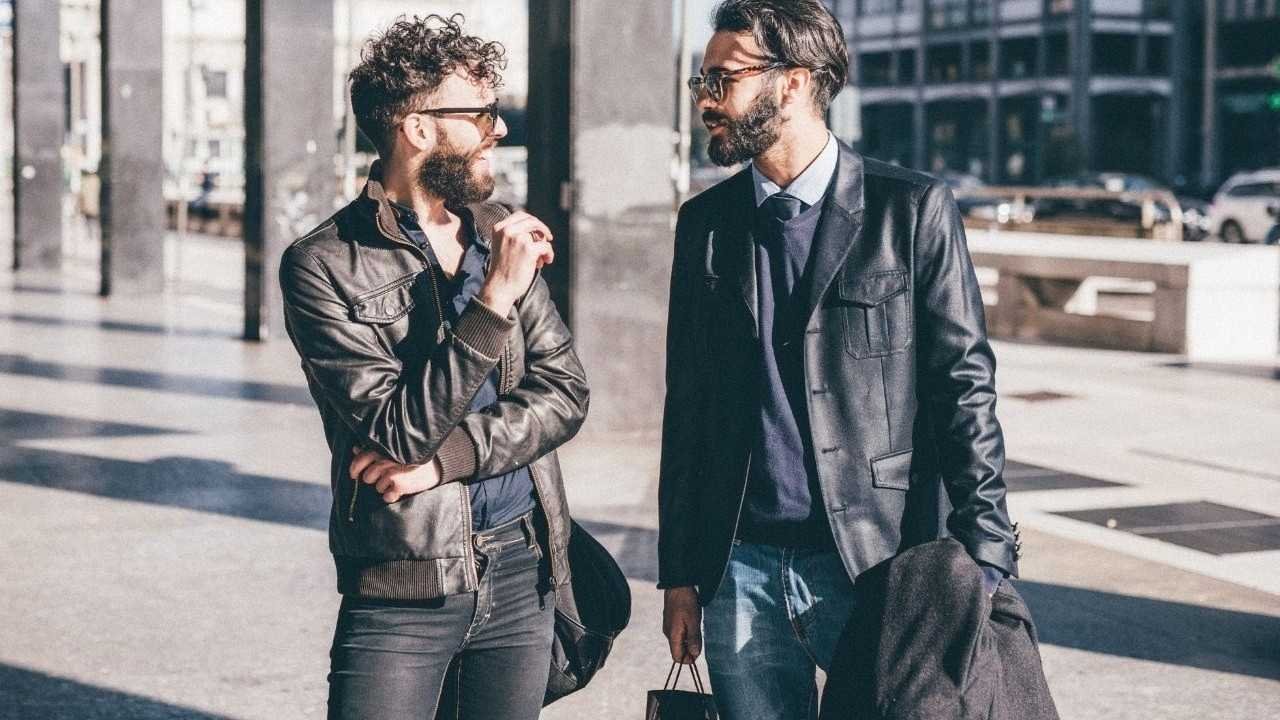 Fashionable guys talking to each other