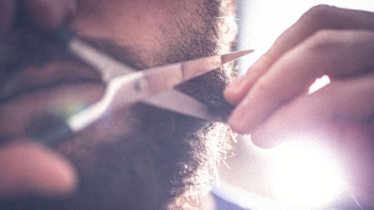 A guy taking care of his beard