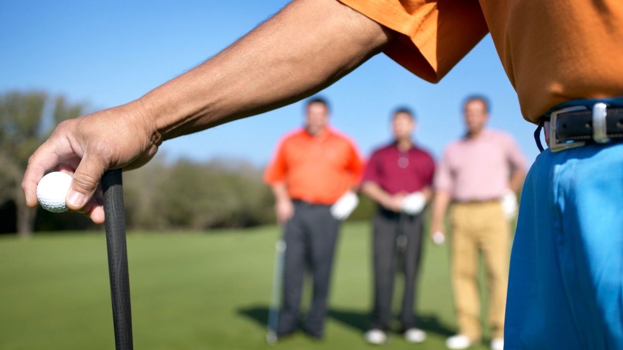 four beginner guys playing golf