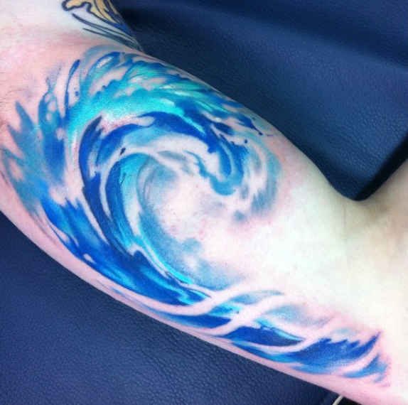 Microrealistic water drop tattoo on the upper arm