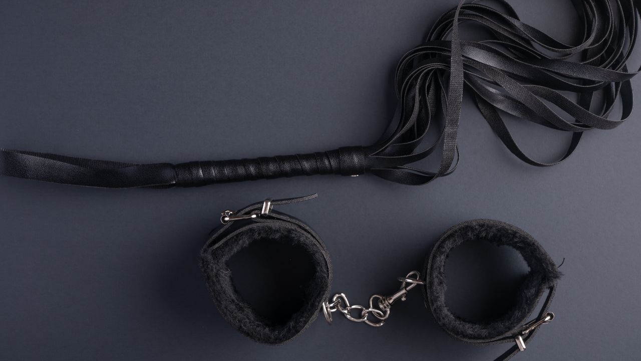 bdsm lash and leather handcuffs