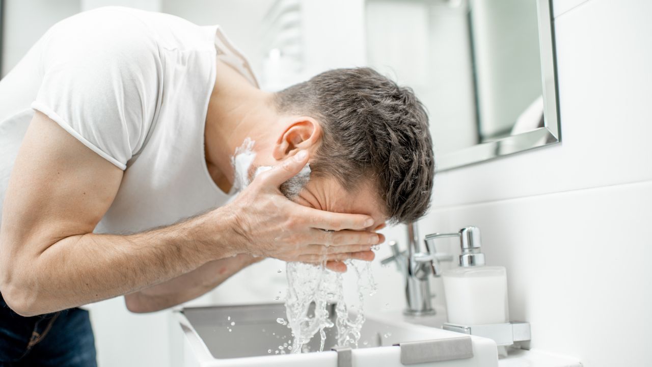 guy washing face