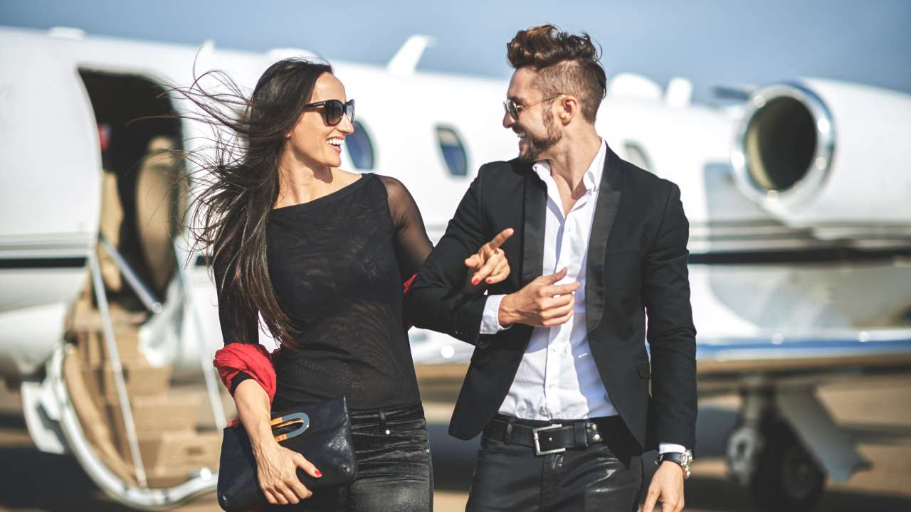couple beside a private jet