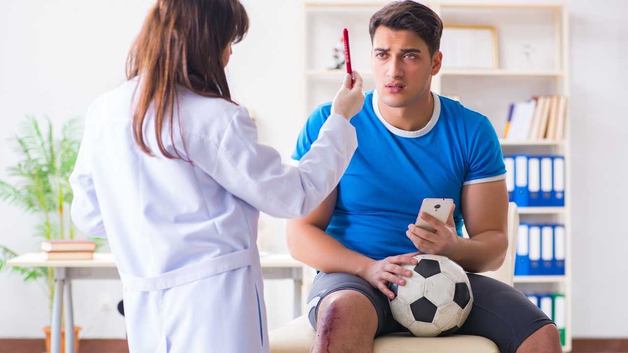 football player visiting doctor after injury
